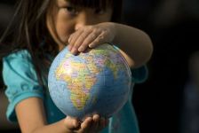 A girl holding the earth in her hands